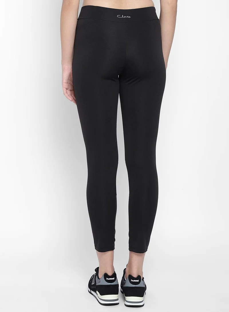 Clovia Black Snug Fit Active Tights in Black with Reflective Logo for Women | Best Price UAE